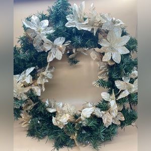 Wreath with faux gold flowers and lights.